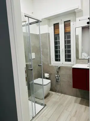 a bathroom with a toilet and a glass shower at Cappadocia Rooms in Rome