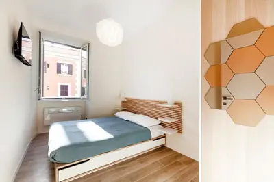 a small bedroom with a bed and a window at Trendy apartment at Vatican in Rome