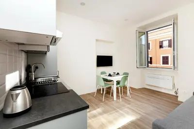 a kitchen and dining room with a table and chairs at Trendy apartment at Vatican in Rome