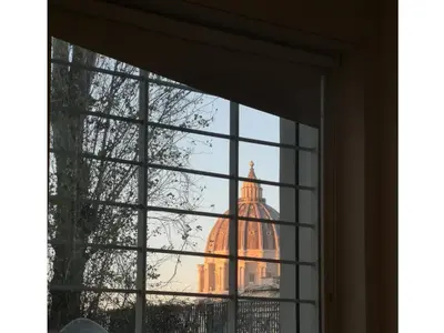 a view of a building seen through a window at clivo56 San Pietro Loft in Rome