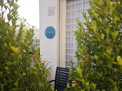 a sign on the side of a building with a bench at clivo56 San Pietro Loft in Rome