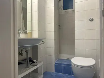 a bathroom with a toilet and a sink at Loft Trastevere in Rome