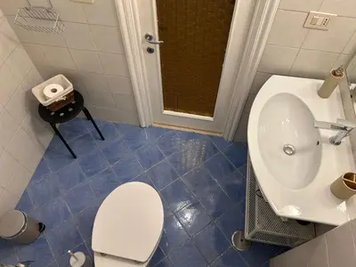 a bathroom with a toilet and a sink at Loft Trastevere in Rome