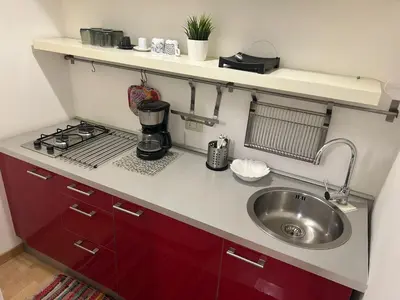 a small kitchen with a sink and a stove at Loft Trastevere in Rome