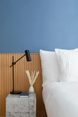a bedroom with a bed and a lamp on a table at Cereate Suites in Rome