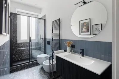 a bathroom with a sink and a toilet and a mirror at Cereate Suites in Rome
