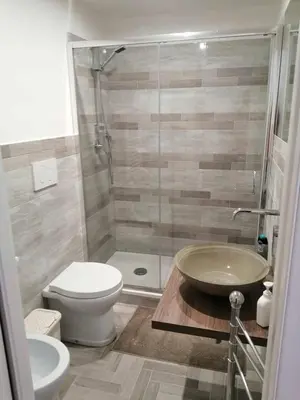 a bathroom with a toilet and a sink and a shower at Art House Vatican Elegante appartamento Centrale in Rome