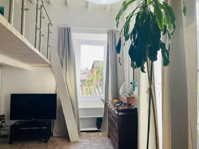 a living room with a staircase and a window at Silent Oasis of Trastevere in Rome