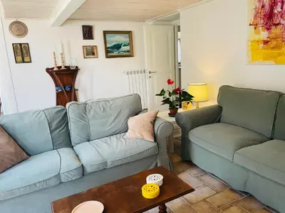 a living room with two blue couches and a table at Silent Oasis of Trastevere in Rome
