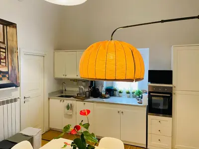 a kitchen with a table and a light fixture at Silent Oasis of Trastevere in Rome