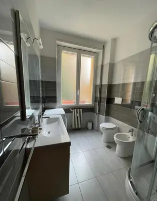 a bathroom with two sinks and a toilet and a shower at Metronio Relax in Rome