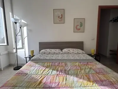 a bedroom with a large bed with a colorful blanket at Metronio Relax in Rome