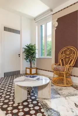 a living room with a table and a chair at Alma at Colosseum Luxury Apartment with View in Rome