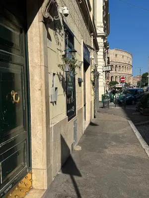 a building with a door on the side of a street at Alma at Colosseum Luxury Apartment with View in Rome