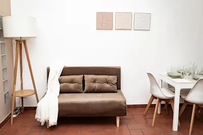 a living room with a couch and a table at Domina Apartments Roma - San Pietro 3 in Rome