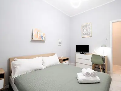 a bedroom with a bed and a desk with a television at Rome Vatican Stay - Appartamento 2 camere da letto vicino al Vaticano in Rome