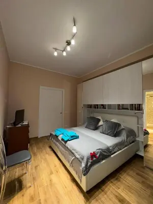 a bedroom with a large bed and a desk at Nicoletti in Rome