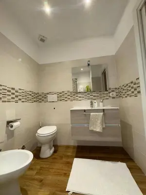 a bathroom with a sink and a toilet and a mirror at Nicoletti in Rome
