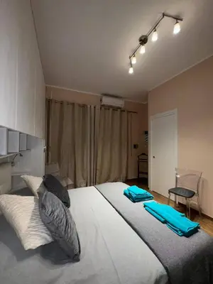 a bedroom with a large bed with blue towels on it at Nicoletti in Rome