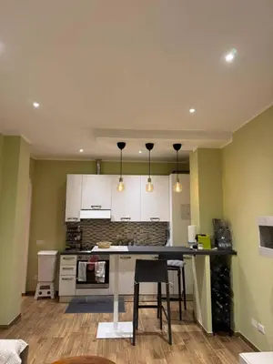 a kitchen with a table and chairs in a room at Nicoletti in Rome