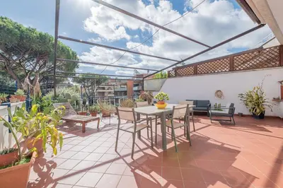 a patio with a table and chairs on a balcony at La Terrazza Loft near San Pietro in Rome