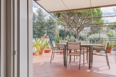 a dining area with a table and chairs on a patio at La Terrazza Loft near San Pietro in Rome