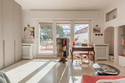 a living room with a table and a window at La Terrazza Loft near San Pietro in Rome