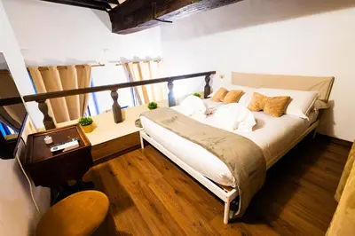 a bedroom with a bed and a table and a chair at Domus Pellegrino heart of ROME in Rome
