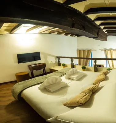 a large white bed with two pillows on it at Domus Pellegrino heart of ROME in Rome