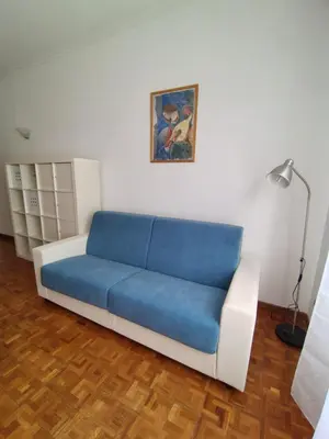 a blue couch in a living room with a lamp at Mary Apartment in Rome