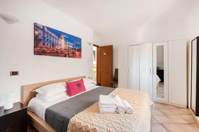 a bedroom with a large bed with towels on it at Vatican San Pietro - Giulia House in Rome