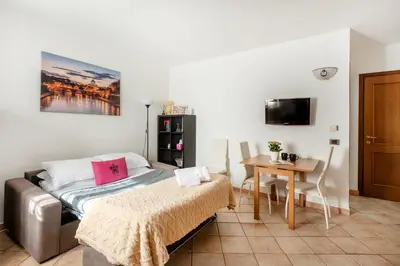 a bedroom with a bed and a small table at Vatican San Pietro - Giulia House in Rome