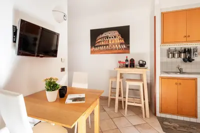 a kitchen with a table and a small kitchen with a dining room at Vatican San Pietro - Giulia House in Rome