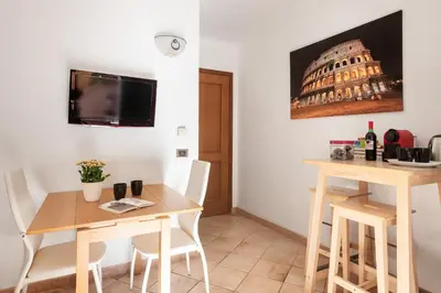 a dining room with a table and a view of the coliseum at Vatican San Pietro - Giulia House in Rome