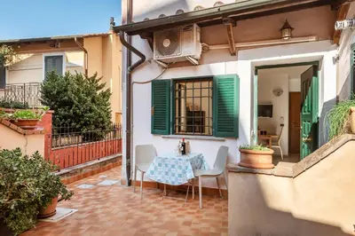 a patio with a table and chairs in a house at Vatican San Pietro - Giulia House in Rome