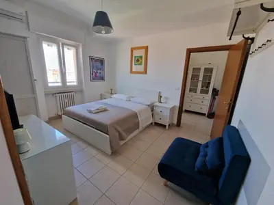 a bedroom with a bed and a desk and a television at Casina Mori in Rome