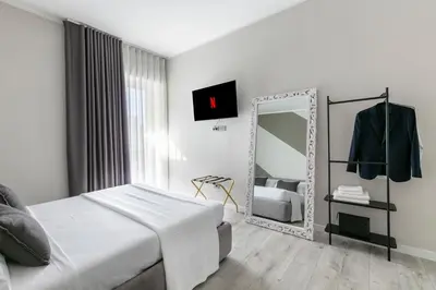 a bedroom with a bed and a mirror at Hotelleria Prestige in Rome