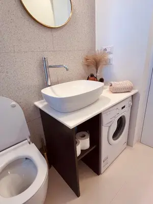 a bathroom with a sink and a washing machine at Clarus apartment in Rome in Rome