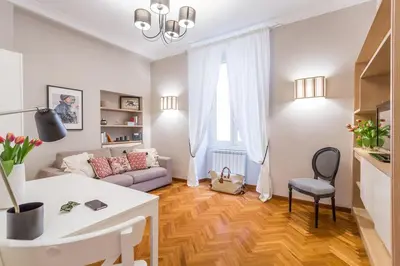 a living room with a couch and a table at Colosseo Elegant Apartment in Rome