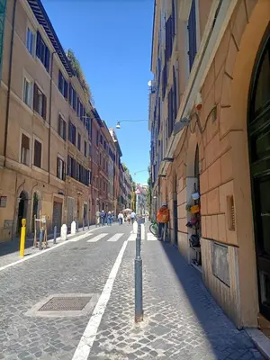 an empty street in a city with buildings at Colosseo Elegant Apartment in Rome