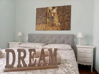 a bedroom with a dream sign on a bed at Colosseo Elegant Apartment in Rome