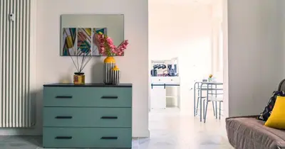 a dresser in a living room with a blue drawer at Desideri di Roma - Basilica San Paolo - Ospedale Bambin Gesu'-Roma III - 8th Piano Vicino la Metro in Rome
