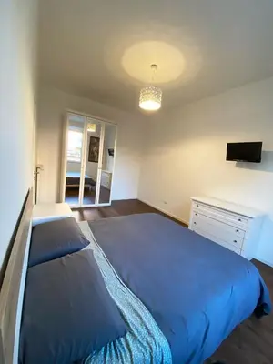 a bedroom with a blue bed and a desk at Domus Quadraro II in Rome