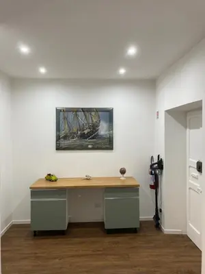a desk in a room with a painting of a ship at Domus Quadraro II in Rome