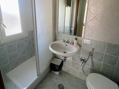 a bathroom with a sink and a shower and a toilet at Bed Bike Breakfast Appartamento Piramide in Rome