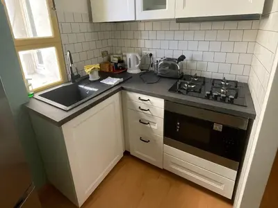 a kitchen with a sink and a stove at Bed Bike Breakfast Appartamento Piramide in Rome
