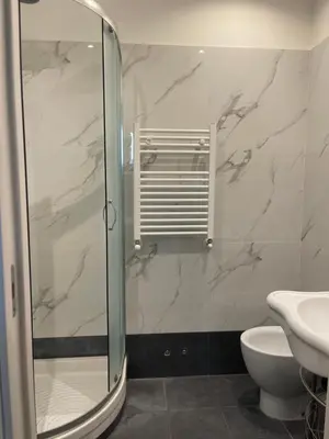 a bathroom with a shower and a toilet and a sink at Ines Stay in Rome