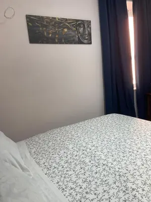 a bed in a bedroom with a picture on the wall at Ines Stay in Rome
