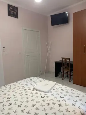a bedroom with a bed and a tv on the wall at Ines Stay in Rome