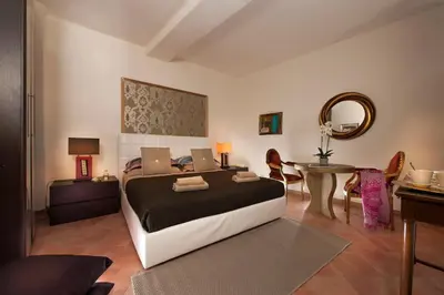 a bedroom with a bed and a table with chairs at La Maison de Kappa in Rome